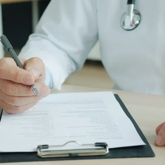 A doctor and a patient going through medical documents together