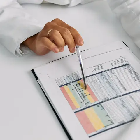 A doctor marking a patient chart