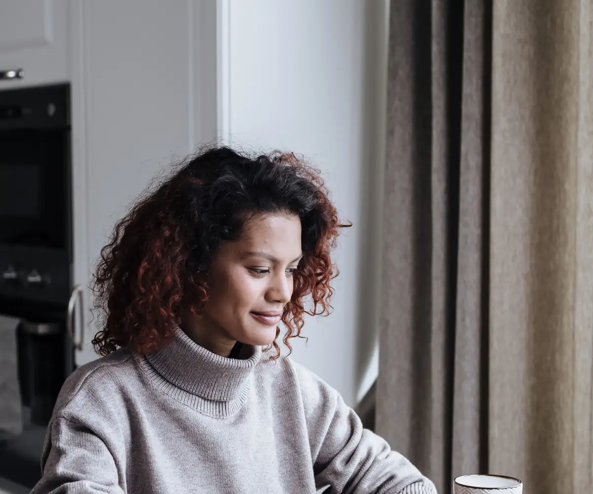 A reader working through her notes at a laptop