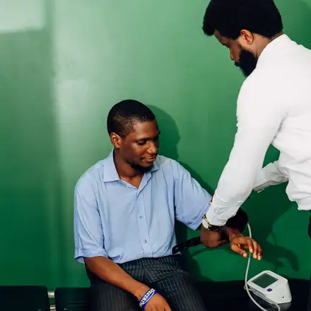 A doctor checking a patient’s blood pressure