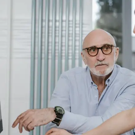 An older patient with his physician at the computer