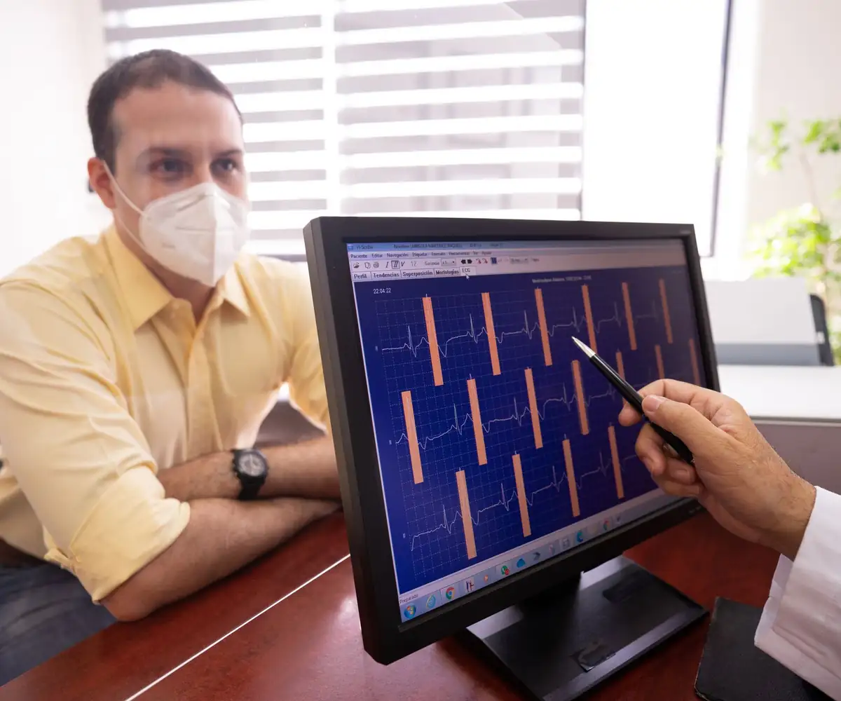 A cardiologist walking a patient through his ECG on a monitor