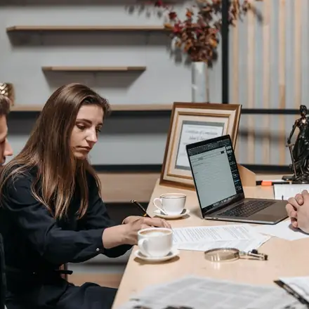 A consultant reviewing documents with practice owners