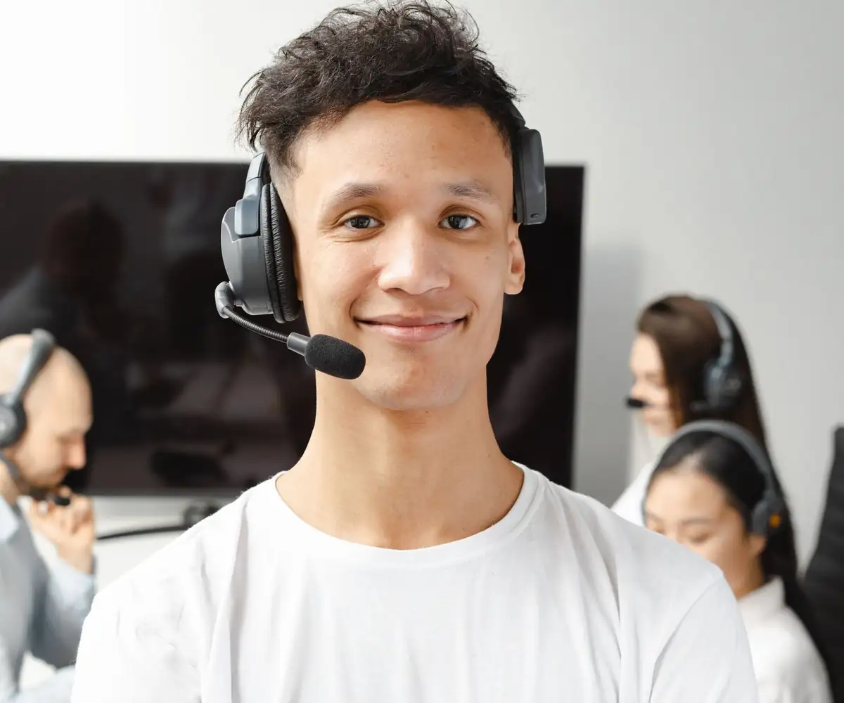 A smiling biller wearing a headset