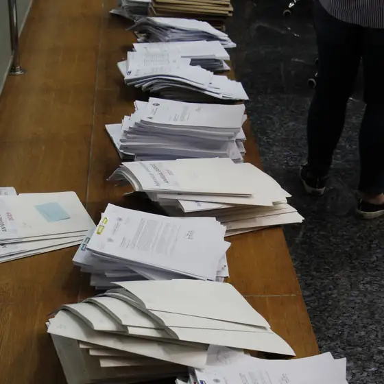 Stacks of claim files on a long table