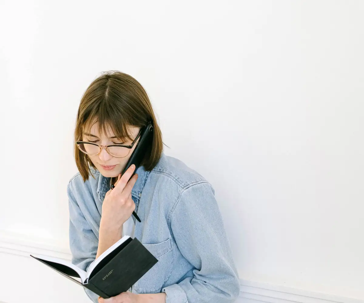 A specialist answering a question by phone