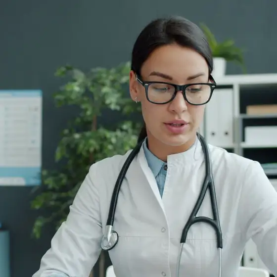 A doctor in her office with her stethoscope