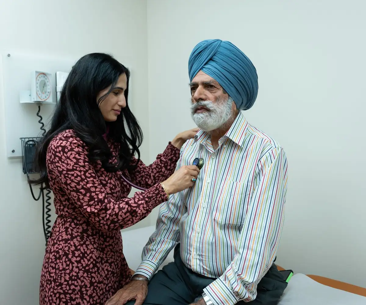 A physician examining an older patient