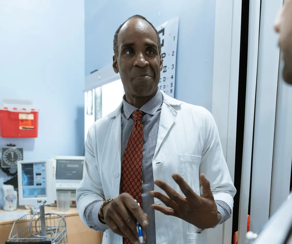 A neurologist showing a brain scan on a tablet