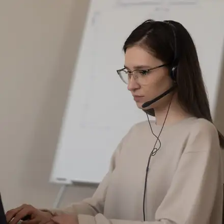 A support agent with a headset helping a patient
