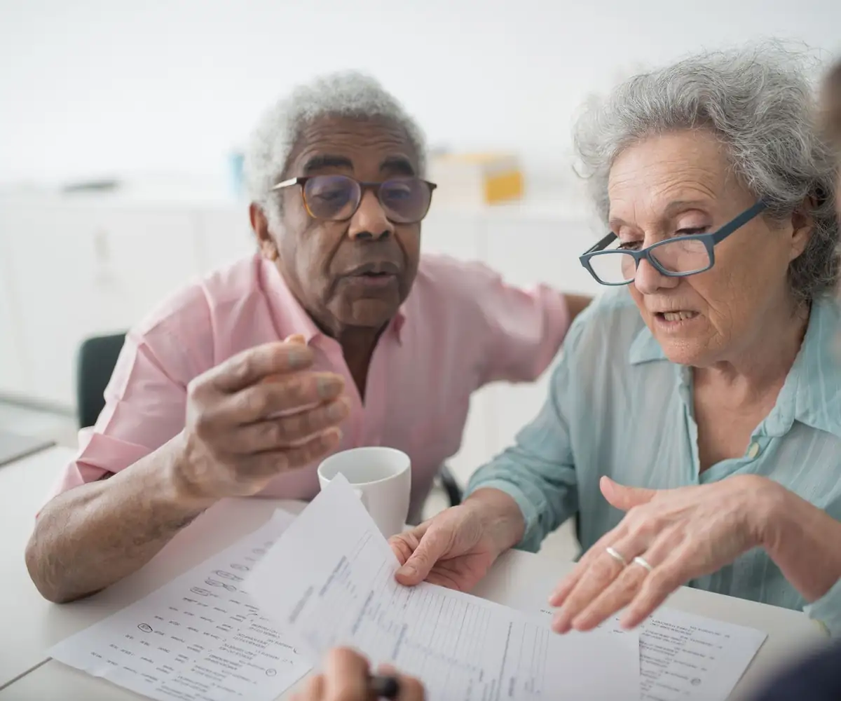 An older couple going through a statement with an advisor