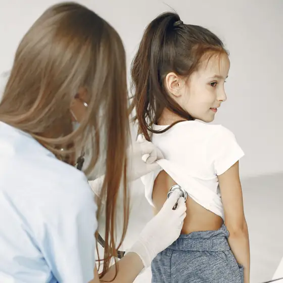 A doctor examining a girl in the clinic