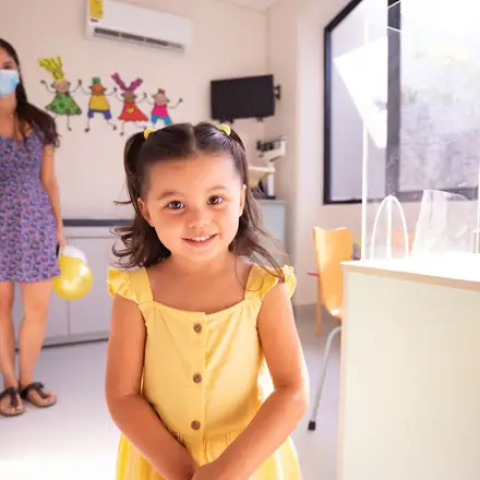 A smiling girl at her pediatric checkup