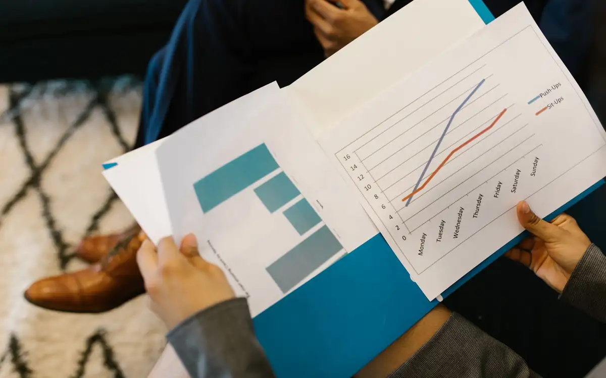 Hands holding a report with a line chart
