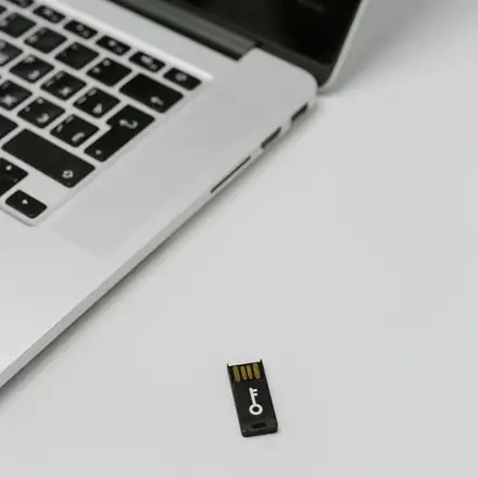 A security key beside a laptop
