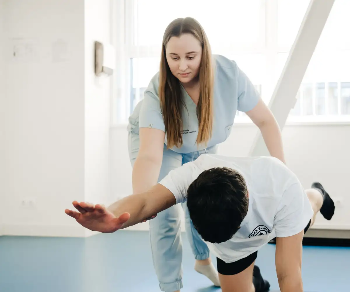 A physical therapist guiding a patient through an exercise