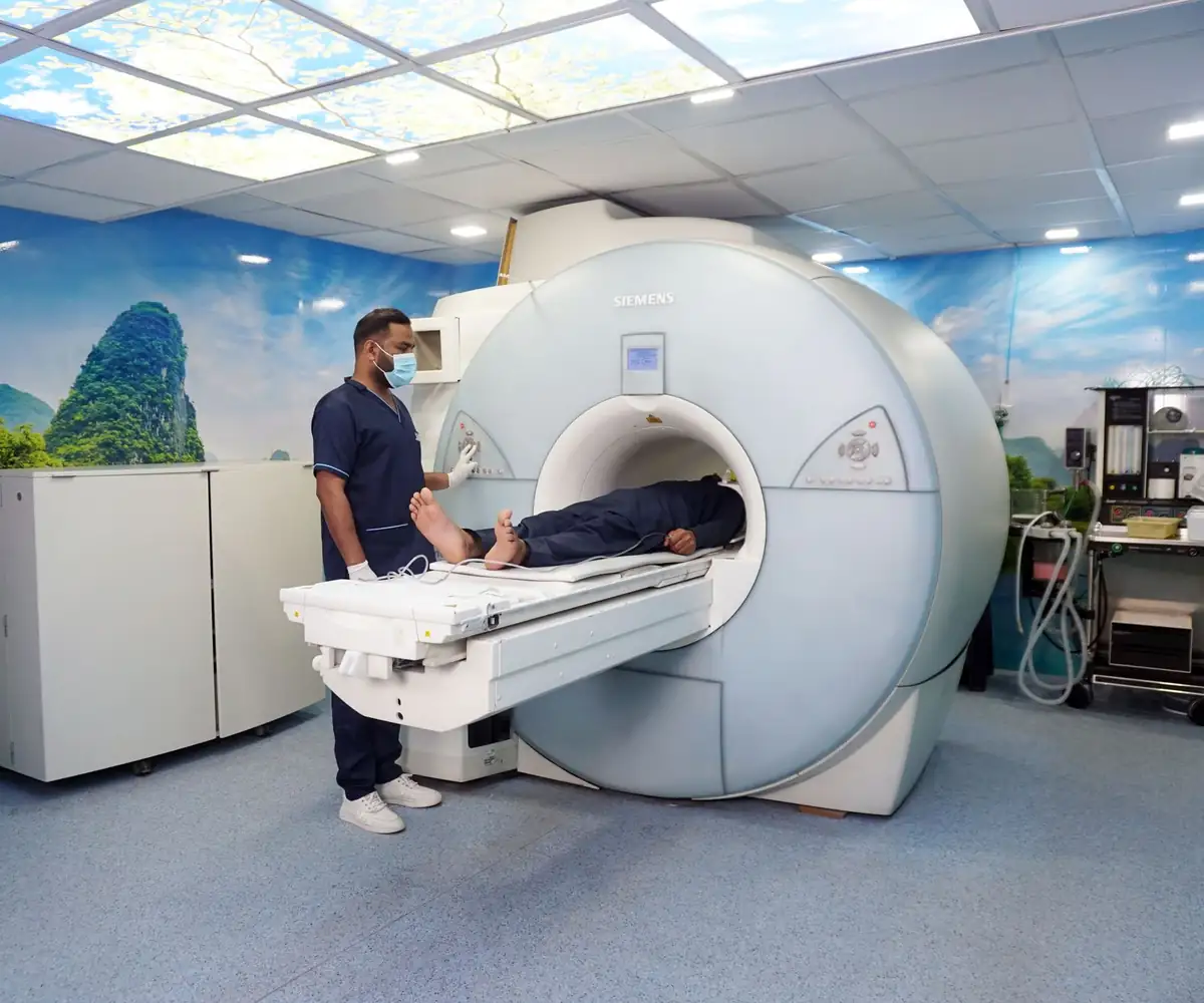 A technologist preparing a patient for an MRI scan