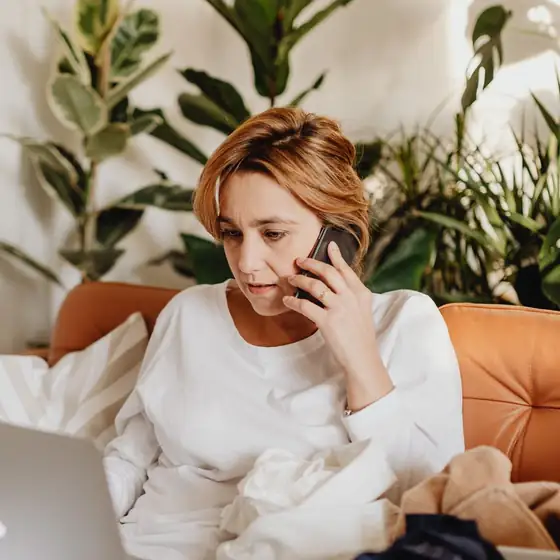 A specialist taking a client call at her laptop