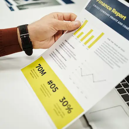 Hands analyzing a finance report