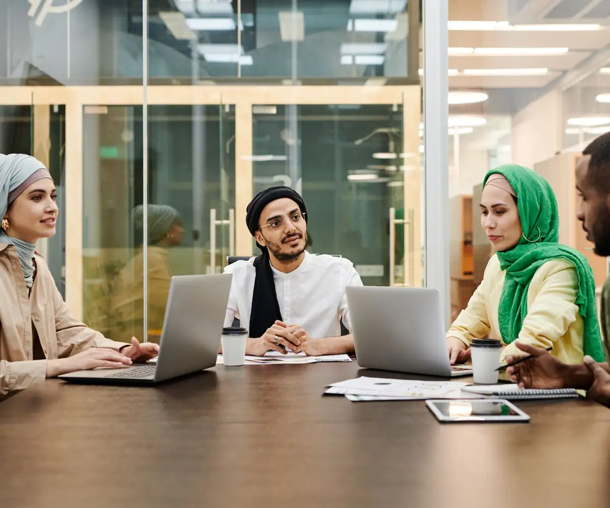 A team working together around their laptops