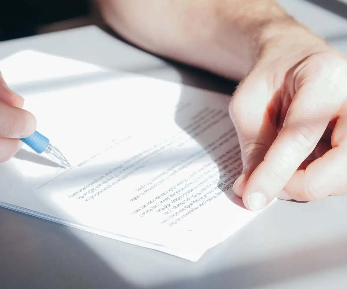 A hand signing an agreement