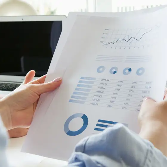 Hands holding a printed results report